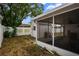 A serene screened porch in a backyard setting, ideal for relaxation with views of the shed and greenery at 8246 Westfield Dr, Port Richey, FL 34668