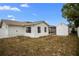 A cozy backyard featuring a well-kept white shed, complemented by simple garden beds and a screened in porch for outdoor relaxation at 8246 Westfield Dr, Port Richey, FL 34668