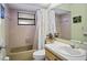 Cozy bathroom featuring a shower and tub combination with a vanity with a sink at 8246 Westfield Dr, Port Richey, FL 34668