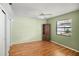 Bright bedroom featuring a closet, wood floors and a ceiling fan at 8246 Westfield Dr, Port Richey, FL 34668