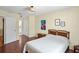 Inviting bedroom showcases wood floors, a closet and a charming flamingo painting at 8246 Westfield Dr, Port Richey, FL 34668