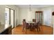 Cozy dining area with hardwood floors, a glass-top table, and sliding glass doors to the outside at 8246 Westfield Dr, Port Richey, FL 34668