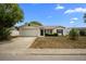 Charming single-story home with a well-maintained front yard and a two-car garage at 8246 Westfield Dr, Port Richey, FL 34668