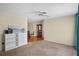 Spacious living room with carpet flooring, ceiling fan, and seamless flow into the dining area at 8246 Westfield Dr, Port Richey, FL 34668