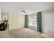 Open-concept living room featuring neutral carpet, ceiling fan, and easy access at 8246 Westfield Dr, Port Richey, FL 34668