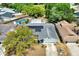 Aerial view of a property with a solar-paneled roof and an enclosed private pool at 8737 Beaver Ln, Port Richey, FL 34668