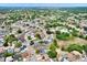 Wide aerial shot of a neighborhood featuring well-maintained homes and lush greenery at 8737 Beaver Ln, Port Richey, FL 34668