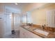 Bathroom featuring double vanity, tile shower, and modern fixtures at 8737 Beaver Ln, Port Richey, FL 34668