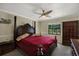 Bedroom with dark wood furniture, ceiling fan, and natural light from a window at 8737 Beaver Ln, Port Richey, FL 34668
