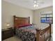 Bedroom with view of backyard, ceiling fan, and classic wood furniture at 8737 Beaver Ln, Port Richey, FL 34668