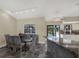 Stylish dining room with a modern table, adjacent to kitchen with high end marble countertops at 8737 Beaver Ln, Port Richey, FL 34668