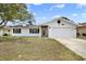 Charming one-story home with white exterior, dark shutters, and well-manicured lawn at 8737 Beaver Ln, Port Richey, FL 34668