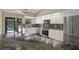 Bright kitchen with white cabinets, stainless steel appliances, and stylish granite countertops at 8737 Beaver Ln, Port Richey, FL 34668