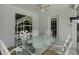 Bright patio showcasing white lattice furniture and a stylish glass-top table at 8737 Beaver Ln, Port Richey, FL 34668