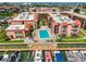 Aerial view showcasing the condo complex with a central pool and private boat docks at 8931 Blind Pass Rd # 262, St Pete Beach, FL 33706
