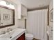 Bathroom with vanity, framed mirror, medicine cabinet and tiled shower at 8931 Blind Pass Rd # 262, St Pete Beach, FL 33706