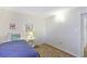A simple bedroom with carpeted floors, neutral walls, and a side table at 8931 Blind Pass Rd # 262, St Pete Beach, FL 33706