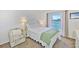 Bedroom has waterfront views with a large window, comfortable furniture, and a light color palette at 8931 Blind Pass Rd # 262, St Pete Beach, FL 33706