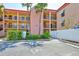 Condo exterior showing well-maintained landscaping, assigned parking, and building access at 8931 Blind Pass Rd # 262, St Pete Beach, FL 33706