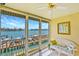 Enclosed lanai boasts bright views of the waterfront with a wicker sofa and tiled floors at 8931 Blind Pass Rd # 262, St Pete Beach, FL 33706
