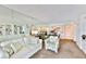 Comfortable living room featuring a mirrored wall, built-in shelving, and views of the kitchen at 8931 Blind Pass Rd # 262, St Pete Beach, FL 33706