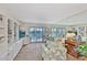Inviting living room with a waterfront view, built-in shelving, and comfortable seating at 8931 Blind Pass Rd # 262, St Pete Beach, FL 33706