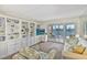 Cozy living room with waterfront views, built-in shelving, and neutral decor at 8931 Blind Pass Rd # 262, St Pete Beach, FL 33706