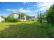 Lush backyard features a manicured lawn with privacy fence and ample space for relaxation at 9059 Spruce Creek Cir, Riverview, FL 33578