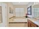 Beautiful bathroom with a large soaking tub, tiled surround, and a vanity at 9059 Spruce Creek Cir, Riverview, FL 33578