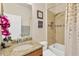 Bathroom with a granite-style sink, a shower-tub combo, and decorative floral accents at 9059 Spruce Creek Cir, Riverview, FL 33578