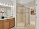 The primary bathroom showcases a glass-enclosed shower with decorative tile at 9059 Spruce Creek Cir, Riverview, FL 33578