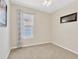 Cozy bedroom with neutral walls, a window with curtains, and carpet flooring at 9059 Spruce Creek Cir, Riverview, FL 33578