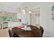 A modern dining area with a dark wood table and chairs at 9059 Spruce Creek Cir, Riverview, FL 33578