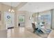 Elegant dining room with modern lighting, large windows, and a view into adjacent rooms at 9059 Spruce Creek Cir, Riverview, FL 33578