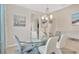 Elegant dining room featuring a glass table, modern lighting, and stylish decor at 9059 Spruce Creek Cir, Riverview, FL 33578