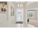 Inviting foyer with tiled floor, decorative lighting, and a view into adjacent rooms at 9059 Spruce Creek Cir, Riverview, FL 33578