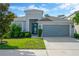 Charming single-Gathering home with a well-manicured lawn and a two-car garage in a residential neighborhood at 9059 Spruce Creek Cir, Riverview, FL 33578