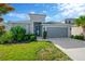 Single-Gathering home with a well-manicured lawn, garden, and a two-car garage at 9059 Spruce Creek Cir, Riverview, FL 33578