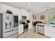 This bright kitchen features stainless steel appliances and white cabinetry at 9059 Spruce Creek Cir, Riverview, FL 33578