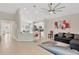 Open-concept living space with tile flooring, a breakfast bar, and comfortable seating at 9059 Spruce Creek Cir, Riverview, FL 33578