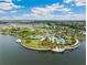 Aerial view of community featuring lakes, pools, clubhouse, tennis courts, and lush landscaping at 9313 Lemon Drop Loop, Ruskin, FL 33573