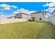 Spacious backyard has lush grass, a white fence, and views of the surrounding houses at 9313 Lemon Drop Loop, Ruskin, FL 33573