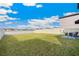 Expansive backyard with healthy green grass, privacy fence, and nearby lake view at 9313 Lemon Drop Loop, Ruskin, FL 33573