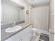 Well-lit bathroom features a granite-topped vanity and shower with neutral tones at 9313 Lemon Drop Loop, Ruskin, FL 33573