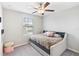 Neutral bedroom with comfortable daybed and view from the window at 9313 Lemon Drop Loop, Sun City Center, FL 33573