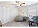 Bright bedroom with closet, ceiling fan, and adjacent desk- perfect for study or work at 9313 Lemon Drop Loop, Ruskin, FL 33573