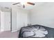 This cozy bedroom features a ceiling fan and closet for ample storage at 9313 Lemon Drop Loop, Ruskin, FL 33573