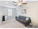 Cozy bonus room with neutral carpet, ceiling fan, and comfortable seating at 9313 Lemon Drop Loop, Ruskin, FL 33573