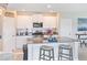 Modern kitchen with white cabinets, granite countertops, and stainless steel appliances at 9313 Lemon Drop Loop, Ruskin, FL 33573