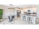 Modern kitchen with granite countertops, stainless steel appliances, island seating and modern lighting at 9313 Lemon Drop Loop, Ruskin, FL 33573